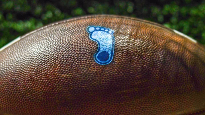 Oct 30, 2021; South Bend, Indiana, USA; A detail of the North Carolina Tar Heels logo on a football during the game against the Notre Dame Fighting Irish at Notre Dame Stadium. Mandatory Credit: Matt Cashore-Imagn Images