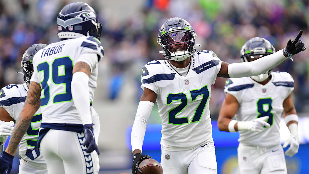 Dec 4, 2022; Inglewood, California, USA; Seattle Seahawks cornerback Tariq Woolen (27) celebrates after intercepting a pass intended for Los Angeles Rams running back Kyren Williams (23) during the first half at SoFi Stadium.