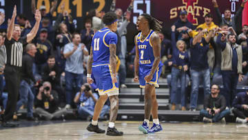 Jan 18, 2025; Morgantown, West Virginia, USA; West Virginia Mountaineers guard Javon Small (7) celebrates with West Virginia Mountaineers guard Jonathan Powell (11) after making a three-point basket late in the second half against the Iowa State Cyclones at WVU Coliseum. Mandatory Credit: Ben Queen-Imagn Images