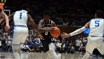 Nov 10, 2023; Durham, North Carolina, USA;  Arizona Wildcats guard Jaden Bradley (0) drives to the basket as Duke Blue Devils guard Caleb Foster (1) and guard Tyrese Proctor(5) defend during the first half at Cameron Indoor Stadium. Mandatory Credit: Rob Kinnan-Imagn Images