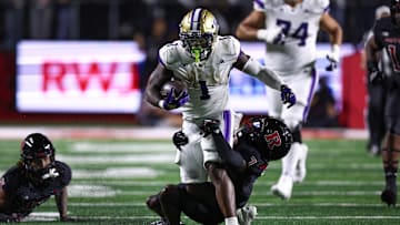 Sep 27, 2024; Piscataway, New Jersey, USA; Washington Huskies running back Jonah Coleman (1) is tackled by Rutgers Scarlet Knights defensive back Robert Longerbeam (7) during the first half at SHI Stadium. Mandatory Credit: Vincent Carchietta-Imagn Images