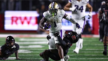 Sep 27, 2024; Piscataway, New Jersey, USA; Washington Huskies running back Jonah Coleman (1) is tackled by Rutgers Scarlet Knights defensive back Robert Longerbeam (7) during the first half at SHI Stadium. Mandatory Credit: Vincent Carchietta-Imagn Images