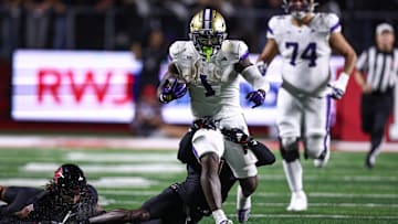 Sep 27, 2024; Piscataway, New Jersey, USA; Washington Huskies running back Jonah Coleman (1) is tackled by Rutgers Scarlet Knights defensive back Robert Longerbeam (7) during the first half at SHI Stadium. Mandatory Credit: Vincent Carchietta-Imagn Images