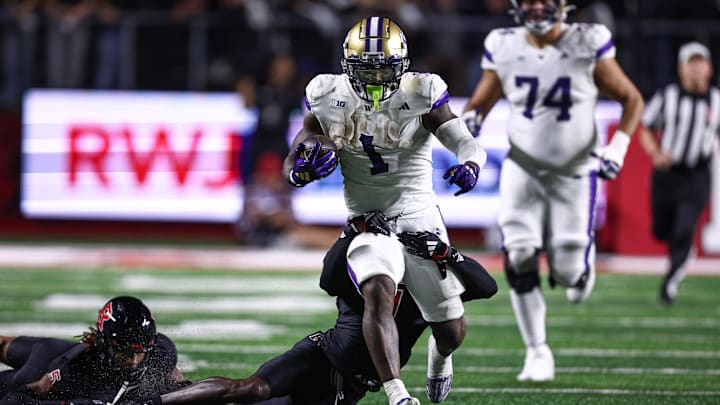 Sep 27, 2024; Piscataway, New Jersey, USA; Washington Huskies running back Jonah Coleman (1) is tackled by Rutgers Scarlet Knights defensive back Robert Longerbeam (7) during the first half at SHI Stadium. Mandatory Credit: Vincent Carchietta-Imagn Images