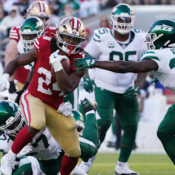 Sep 9, 2024; Santa Clara, California, USA; San Francisco 49ers running back Jordan Mason (24) avoids the grasp of New York Jets safety Tony Adams (22) in the second quarter at Levi's Stadium.