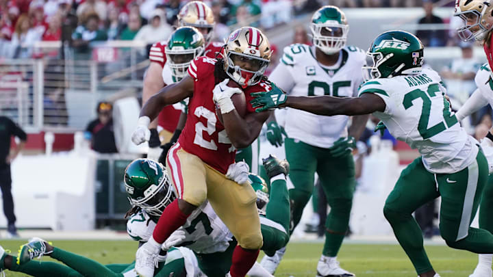 Sep 9, 2024; Santa Clara, California, USA; San Francisco 49ers running back Jordan Mason (24) avoids the grasp of New York Jets safety Tony Adams (22) in the second quarter at Levi's Stadium.