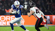 Nov 9, 2025; Berlin, Germany; Indianapolis Colts tight end Tyler Warren (84) runs against Atlanta Falcons linebacker JD Bertrand (40) during the NFL Berlin Game at Olympic Stadium. Mandatory Credit: Kirby Lee-Imagn Images