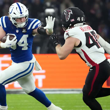 Nov 9, 2025; Berlin, Germany; Indianapolis Colts tight end Tyler Warren (84) runs against Atlanta Falcons linebacker JD Bertrand (40) during the NFL Berlin Game at Olympic Stadium. Mandatory Credit: Kirby Lee-Imagn Images