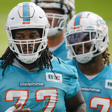 Miami Dolphins defensive tackle John Jenkins (77) runs on the field during minicamp at Baptist Health Training Complex in 2022.\