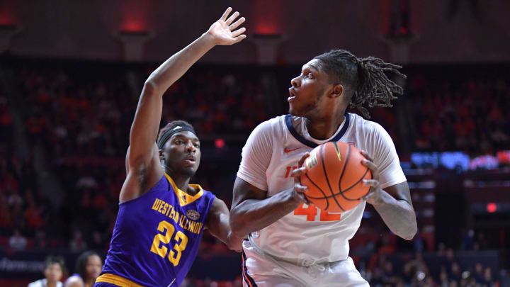 Nov 24, 2023; Champaign, Illinois, USA;  Illinois Fighting Illini forward Dain Dainja (42) looks to the basket while Western Illinois Leathernecks center Drew Cisse (23) defends during the first half at State Farm Center. Mandatory Credit: Ron Johnson-USA TODAY Sports