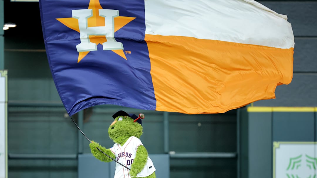 Houston Astros mascot Orbit waves a flag