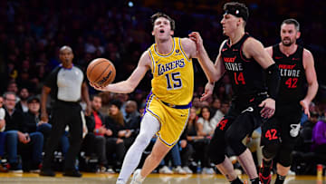 Jan 3, 2024; Los Angeles, California, USA; Los Angeles Lakers guard Austin Reaves (15) moves the ball against Miami Heat guard Tyler Herro (14) during the second half at Crypto.com Arena. Mandatory Credit: Gary A. Vasquez-Imagn Images