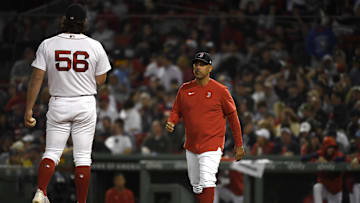 May 31, 2022; Boston, Massachusetts, USA;  Boston Red Sox manager Alex Cora (13) walks to the mound to relieve relief pitcher Austin Davis (56) during the seventh inning against the Cincinnati Reds at Fenway Park. Mandatory Credit: Bob DeChiara-Imagn Images