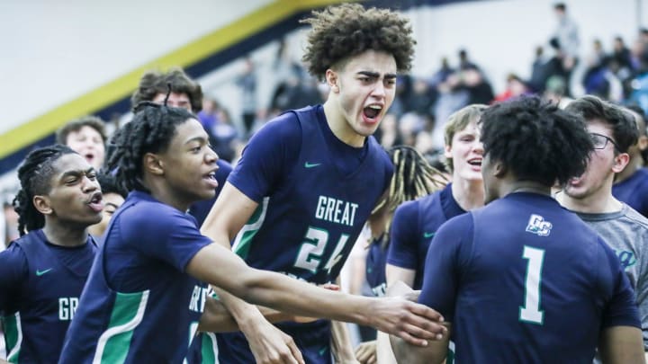 Great Crossing's Malachi Moreno (24) and teammates mob Vince Dawson (1) in jubilation after Dawson's last second shot lifted the Warhawks 48-46 over Newport at Thursday's 2023 Chad Gardner Law King of the Bluegrass holiday basketball tournament at Fairdale High School. Dec. 21, 2023