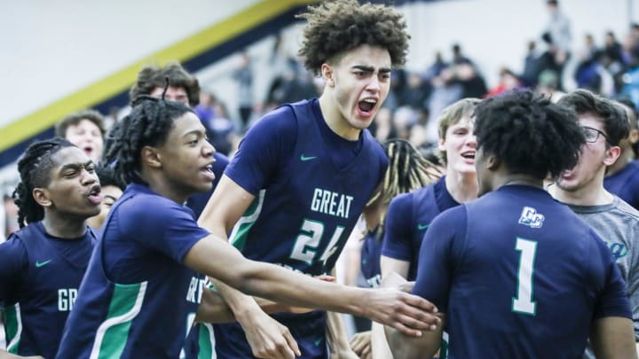 Great Crossing's Malachi Moreno (24) and teammates celebrate the Warhawks' 48-46 over Newport at the 2023 Chad Gardner Law King of the Bluegrass holiday basketball tournament.