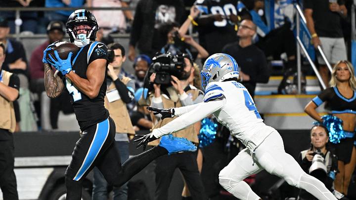 Oct 4, 2026; Charlotte, North Carolina, USA;  Carolina Panthers wide receiver Tetairoa McMillan (4) makes a catch defended by Detroit Lions cornerback D.J. Reed (4) during the second quarter at Bank of America Stadium. McMillan scored a touchdown on the play.  Mandatory Credit: Bob Donnan-Imagn Images