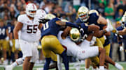Notre Dame linebacker Kyngstonn Viliamu-Asa (27) tackles Stanford wide receiver Elic Ayomanor (13) during a NCAA college football game between Notre Dame and Stanford at Notre Dame Stadium on Saturday, Oct. 12, 2024, in South Bend.
