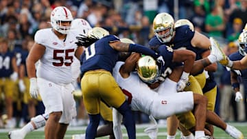 Notre Dame linebacker Kyngstonn Viliamu-Asa (27) tackles Stanford wide receiver Elic Ayomanor (13) during a NCAA college football game between Notre Dame and Stanford at Notre Dame Stadium on Saturday, Oct. 12, 2024, in South Bend.