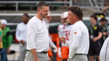 Oregon head coach Dan Lanning, left, and Oklahoma State head coach Mike Gundy talk before the game as the Oregon Ducks host the Oklahoma State Cowboys on Sept. 6, 2025, at Autzen Stadium in Eugene, Oregon.