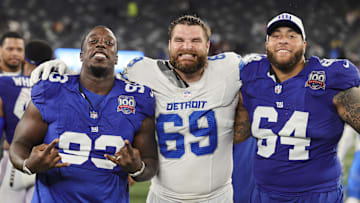 Aug 8, 2024; East Rutherford, New Jersey, USA;  New York Giants defensive tackle Rakeem Nunez-Roches (93), Detroit Lions defensive end Pat O'Connor (69) and New York Giants guard Aaron Stinnie (64) pose for a group photo after their preseason game at MetLife Stadium. Mandatory Credit: Scott Rausenberger-Imagn Images