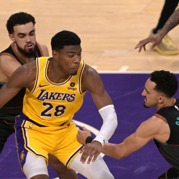 Feb 29, 2024; Los Angeles, California, USA;  Los Angeles Lakers forward Rui Hachimura (28) loses control of the ball as he is defended by Washington Wizards guard Tyus Jones (5) and guard Landry Shamet (20) in the first half at Crypto.com Arena. Mandatory Credit: Jayne Kamin-Oncea-USA TODAY Sports