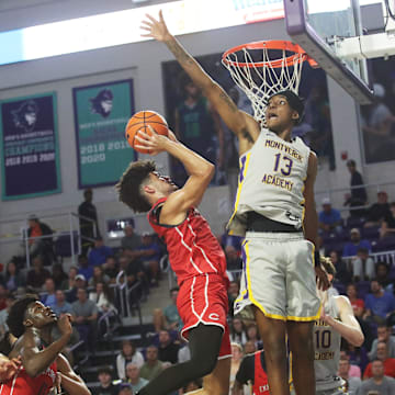 Cayden Boozer of the Miami Columbus High School basketball team drives to the basket during the championship game against Montverde at the City of Palms Classic at Suncoast Credit Union Arena in Fort Myers on Monday, Dec. 23, 2024. He is defended by Hakeem Weems of Montverde Acdademy. Miami Columbus won.