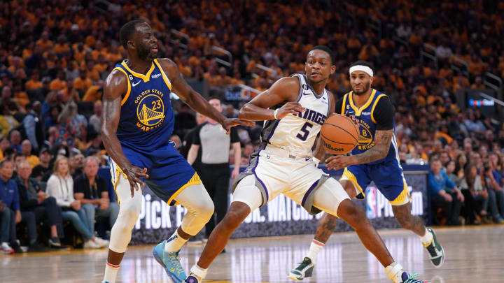 Apr 28, 2023; San Francisco, California, USA; Sacramento Kings guard De'Aaron Fox (5) holds onto the ball next to Golden State Warriors forward Draymond Green (23) in the third quarter during game six of the 2023 NBA playoffs at the Chase Center. Mandatory Credit: Cary Edmondson-USA TODAY Sports