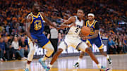 Apr 28, 2023; San Francisco, California, USA; Sacramento Kings guard De'Aaron Fox (5) holds onto the ball next to Golden State Warriors forward Draymond Green (23) in the third quarter during game six of the 2023 NBA playoffs at the Chase Center. Mandatory Credit: Cary Edmondson-Imagn Images