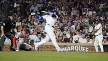 Jun 18, 2024; Chicago, Illinois, USA; Chicago Cubs outfielder Ian Happ (8) hits a one run single against the San Francisco Giants during the eighth inning at Wrigley Field.