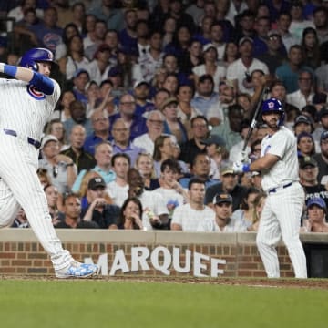Jun 18, 2024; Chicago, Illinois, USA; Chicago Cubs outfielder Ian Happ (8) hits a one run single against the San Francisco Giants during the eighth inning at Wrigley Field.