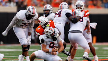 Aug 28, 2025; Stillwater, Oklahoma, USA; Tennessee Martin Skyhawks quarterback Jase Bauer (8) is sacked by Oklahoma State Cowboys linebacker Wendell Gregory (4) during the first half  at Boone Pickens Stadium. Mandatory Credit: William Purnell-Imagn Images