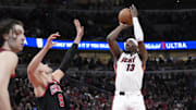 Apr 16, 2025; Chicago, Illinois, USA; Chicago Bulls center Nikola Vucevic (9) defends Miami Heat center Bam Adebayo (13) during the second half at United Center. Mandatory Credit: David Banks-Imagn Images
