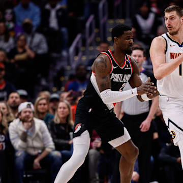 Feb 10, 2025; Denver, Colorado, USA; Denver Nuggets center Nikola Jokic (15) controls the ball as Portland Trail Blazers center Deandre Ayton (2) guards in the first quarter at Ball Arena. Mandatory Credit: Isaiah J. Downing-Imagn Images