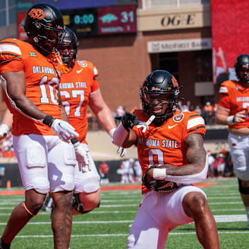 Sep 7, 2024; Stillwater, Oklahoma, USA; Oklahoma State Cowboys running back Ollie Gordon II (0) celebrates in the end zone after scoring during the second overtime against the Arkansas Razorbacks at Boone Pickens Stadium. Mandatory Credit: William Purnell-Imagn Images