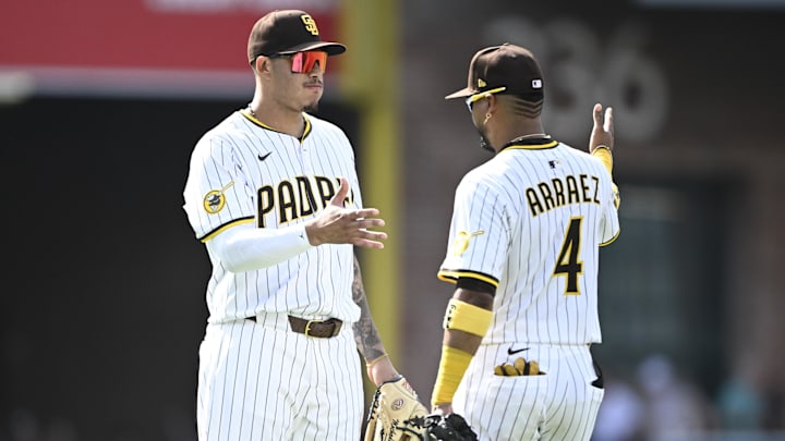 Aug 21, 2025; San Diego, California, USA; San Diego Padres third baseman Manny Machado (13) and Luis Arraez (4) celebrate after the Padres beat the San Francisco Giants at Petco Park. Mandatory Credit: Denis Poroy-Imagn Images
