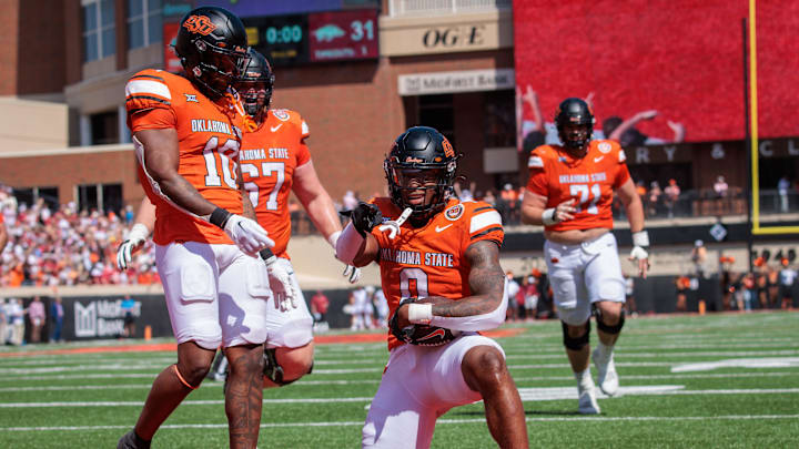 Sep 7, 2024; Stillwater, Oklahoma, USA; Oklahoma State Cowboys running back Ollie Gordon II (0) celebrates in the end zone after scoring during the second overtime against the Arkansas Razorbacks at Boone Pickens Stadium. Mandatory Credit: William Purnell-Imagn Images