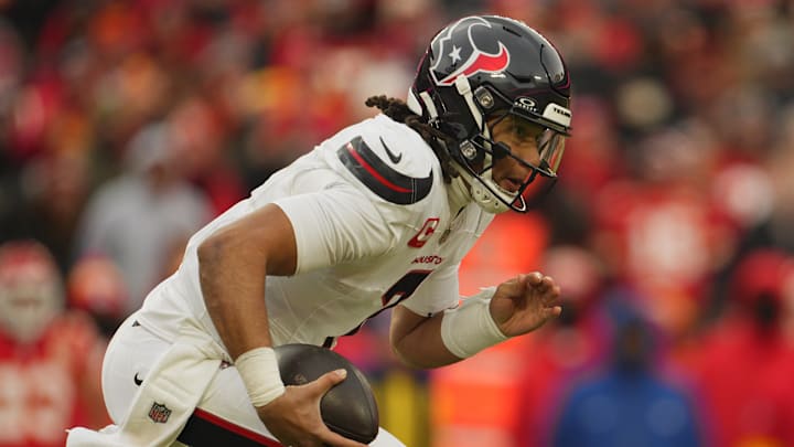 Jan 18, 2025; Kansas City, Missouri, USA; Houston Texans quarterback C.J. Stroud (7) scrambles with the ball against the Kansas City Chiefs during the second quarter of a 2025 AFC divisional round game at GEHA Field at Arrowhead Stadium. Mandatory Credit: Jay Biggerstaff-Imagn Images