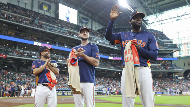 Jul 14, 2024; Houston, Texas, USA; Houston Astros second baseman Jose Altuve (27) and right fielder Kyle Tucker (30) look on as designated hitter Yordan Alvarez (44) waves to the crowd before the game against the Texas Rangers at Minute Maid Park.