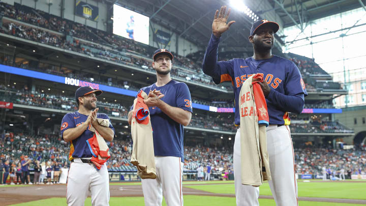 Jul 14, 2024; Houston, Texas, USA; Houston Astros second baseman Jose Altuve (27) and right fielder Kyle Tucker (30) look on as designated hitter Yordan Alvarez (44) waves to the crowd before the game against the Texas Rangers at Minute Maid Park. 