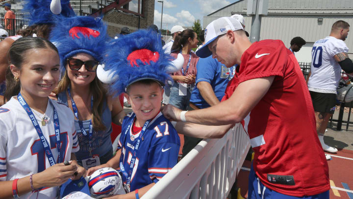 Bills kicker Tyler Bass signs the jersey of Alex Rzepecki, 11, from Phoenix, AZ at the end of day three of the Buffalo Bills training camp. Alex, along with his mother Jennifer Rzepecki, a native of Buffalo, are proudly wearing their Water Buffalo Club hats in support of the Bills.