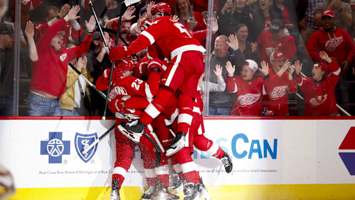 Apr 15, 2024; Detroit, Michigan, USA;  Detroit Red Wings left wing Lucas Raymond (23) receives congratulations from teammates after he scores in overtime against the Montreal Canadiens at Little Caesars Arena. Mandatory Credit: Rick Osentoski-USA TODAY Sports