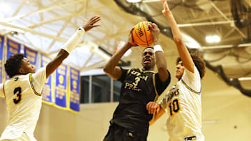 Utah Prep's AJ Dybantsa drives to the basket on Highland's Jemal Smith, left, and Nate Ament during a game at Emmanuel College in Boston on Tuesday, Nov. 5, 2024.