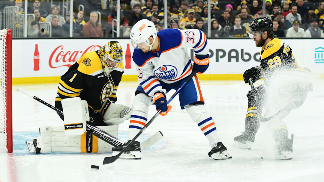 Jan 7, 2025; Boston, Massachusetts, USA;  Edmonton Oilers left wing Viktor Arvidsson (33) plays a rebound in front of Boston Bruins goaltender Jeremy Swayman (1) during the second period at TD Garden. Mandatory Credit: Bob DeChiara-Imagn Images