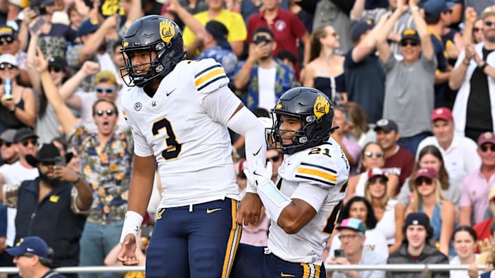 Jaron-Keawe Sagapolutele (3) celebrates a touchdown with receiver Jacob De Jesus Jaron-Keawe Sagapolutele (3) celebrates a touchdown with receiver Jacob De Jesus