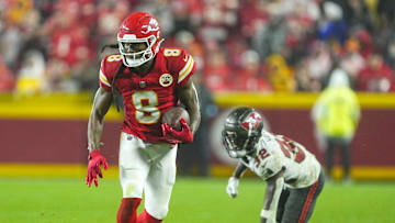 Nov 4, 2024; Kansas City, Missouri, USA; Kansas City Chiefs wide receiver DeAndre Hopkins (8) runs with the ball past Tampa Bay Buccaneers safety Josh Hayes (32) during overtime at GEHA Field at Arrowhead Stadium. Mandatory Credit: Jay Biggerstaff-Imagn Images