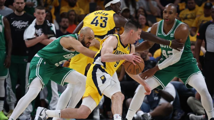 May 25, 2024; Indianapolis, Indiana, USA; Indiana Pacers guard T.J. McConnell (9) dribbles the ball against Boston Celtics guard Derrick White (9) and center Al Horford (42) during the fourth quarter of game three of the eastern conference finals in the 2024 NBA playoffs at Gainbridge Fieldhouse. Mandatory Credit: Trevor Ruszkowski-USA TODAY Sports