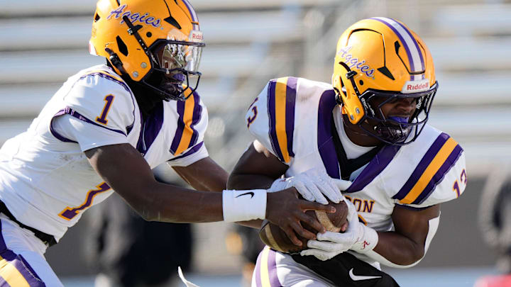 Dec 6, 2024; Birmingham, AL, USA; Jackson's Landon Duckworth (1) hands off to Jackson's Ezavier Crowell (13) as they run a play for a touchdown against Cherokee County at Protective Stadium in the AHSAA 4A State Championship game.