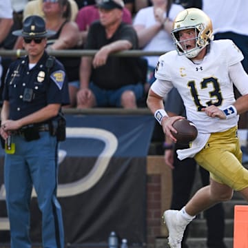 Sep 14, 2024; West Lafayette, Indiana, USA; Notre Dame Fighting Irish quarterback Riley Leonard (13) reacts after scoring a touchdown against the Purdue Boilermakers during the second quarter at Ross-Ade Stadium.