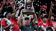 Houston Cougars head coach Kelvin Sampson holds the trophy for winning the Midwest Regional final.