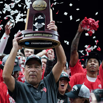 Houston Cougars head coach Kelvin Sampson holds the trophy for winning the Midwest Regional final.